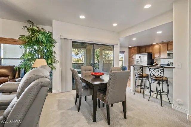 a living room with furniture and a dining table with kitchen view