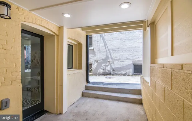 a view of front door with furniture and a window