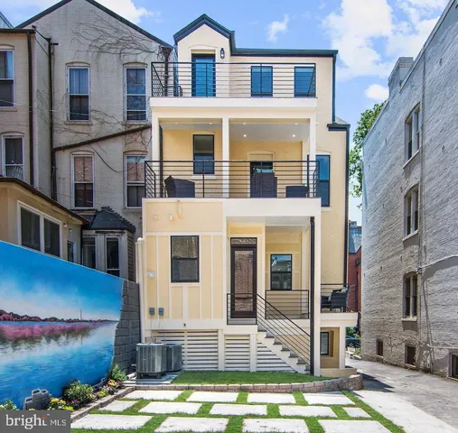 a front view of a building with glass windows and a table