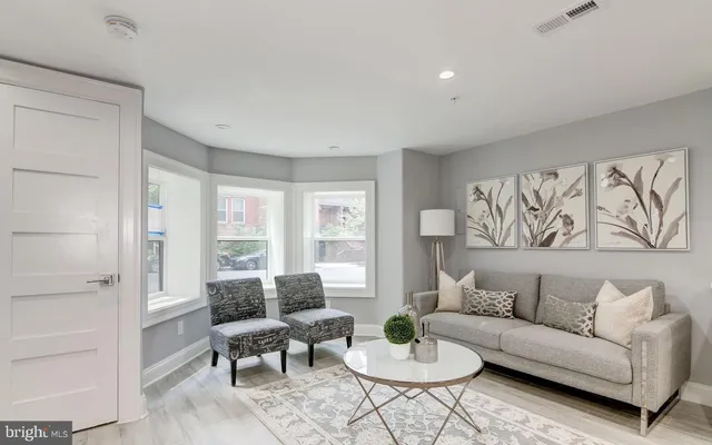 a living room with furniture and a large window