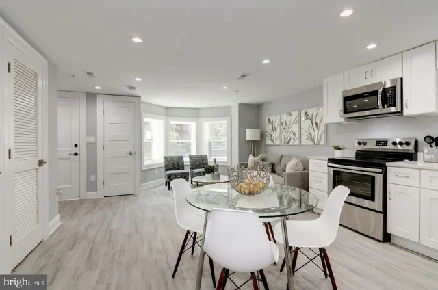 a view of a dining room with furniture and wooden floor