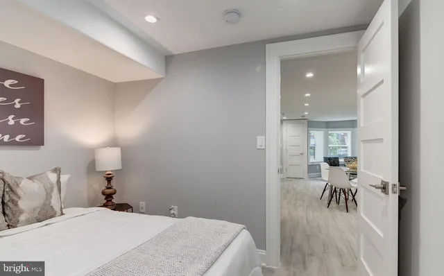 a bedroom with a bed and table chair