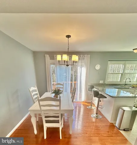 a dining room with furniture and wooden floor