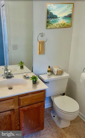 a bathroom with a sink a toilet and mirror