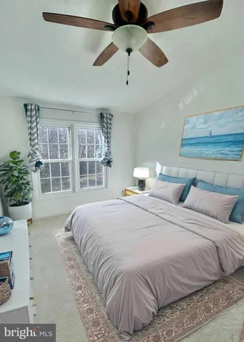 a bedroom with a large bed and a large window