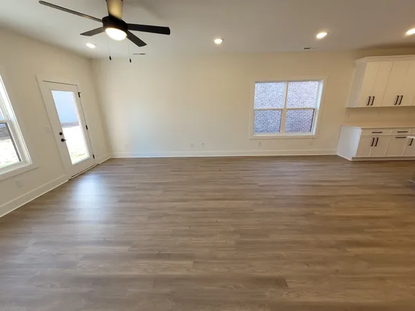 a kitchen with a sink and wooden floor