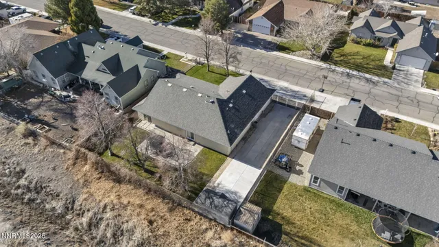 an empty room with wooden floor chandelier and windows