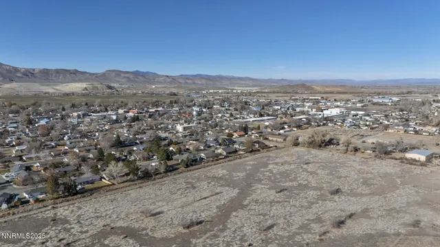 a kitchen with granite countertop a refrigerator and a sink