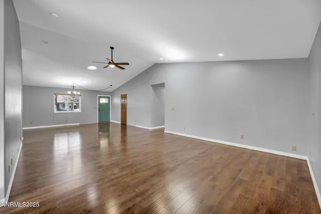 a kitchen with stainless steel appliances granite countertop a refrigerator a sink dishwasher a stove with wooden cabinets and floor