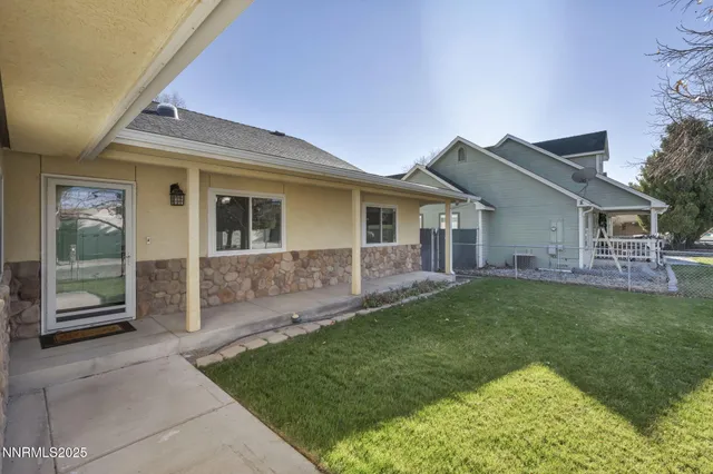 a view of a house with a yard and sitting area