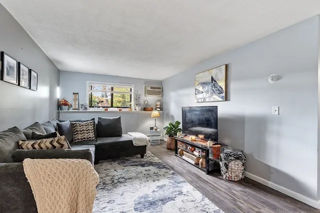 a living room with furniture flat screen tv and a window