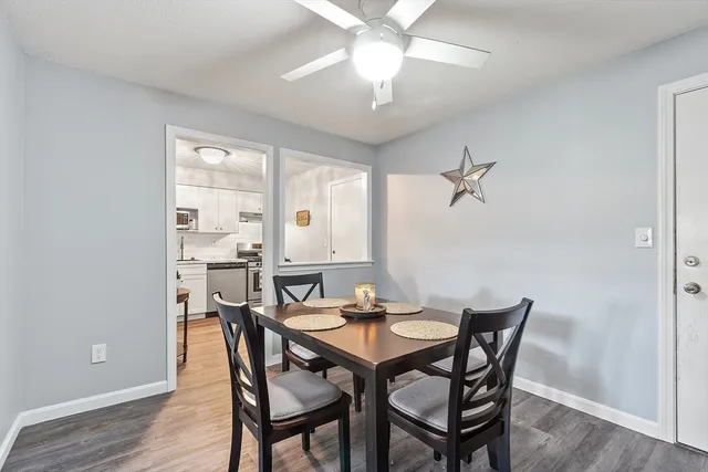 a view of a dining room with furniture and wooden floor
