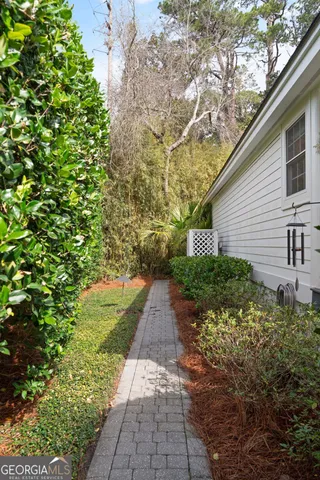 a view of a pathway with a flower garden