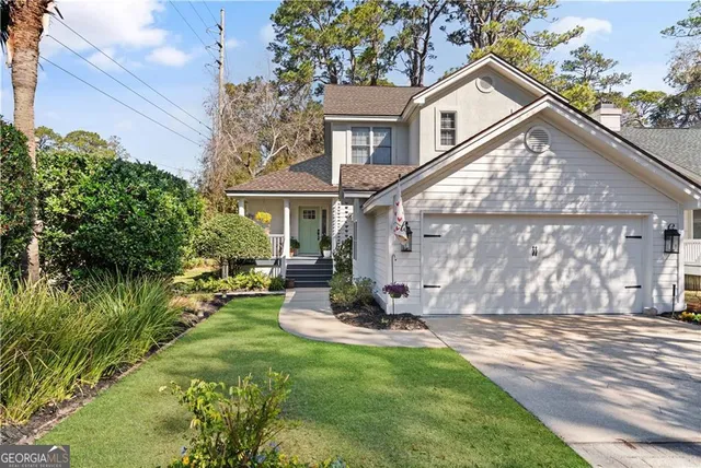 a view of a house with backyard and sitting area