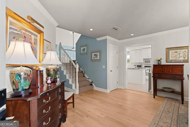 a view of entryway with furniture and wooden floor