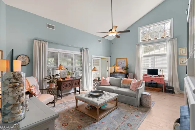 a living room with furniture chandelier and a window