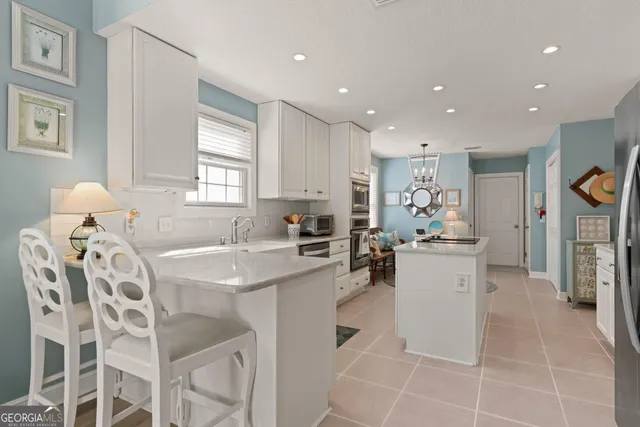 a kitchen with a sink appliances and cabinets