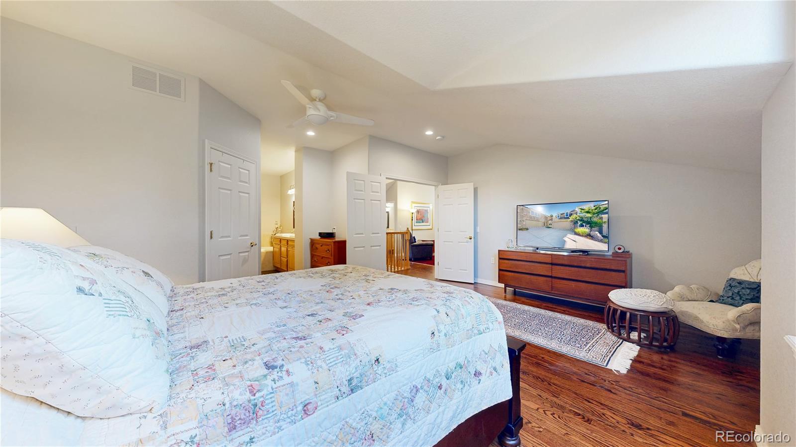 4545 South Monaco Street, Unit 138 Denver, CO 80237 - Photo 13 of 34 a spacious bedroom with a bed and a table in it