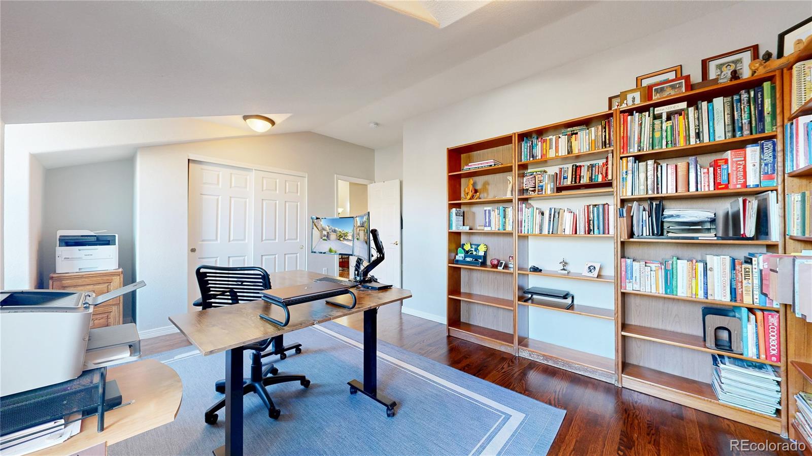 4545 South Monaco Street, Unit 138 Denver, CO 80237 - Photo 19 of 34 a view of a workspace with furniture and a bookshelf