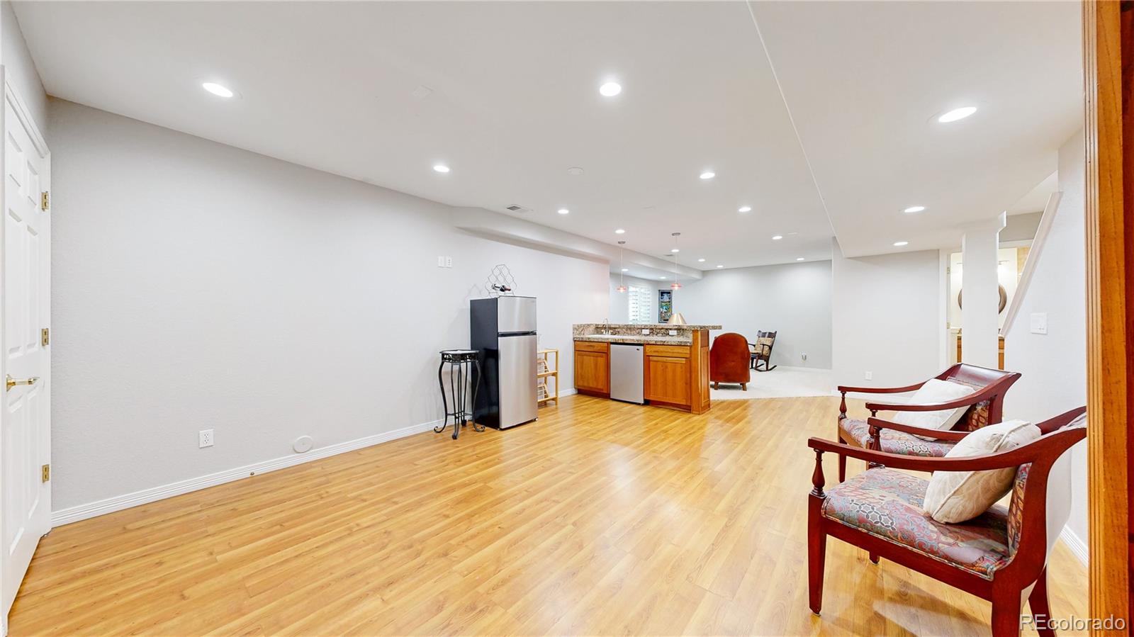 4545 South Monaco Street, Unit 138 Denver, CO 80237 - Photo 27 of 34 a large room with wooden floor