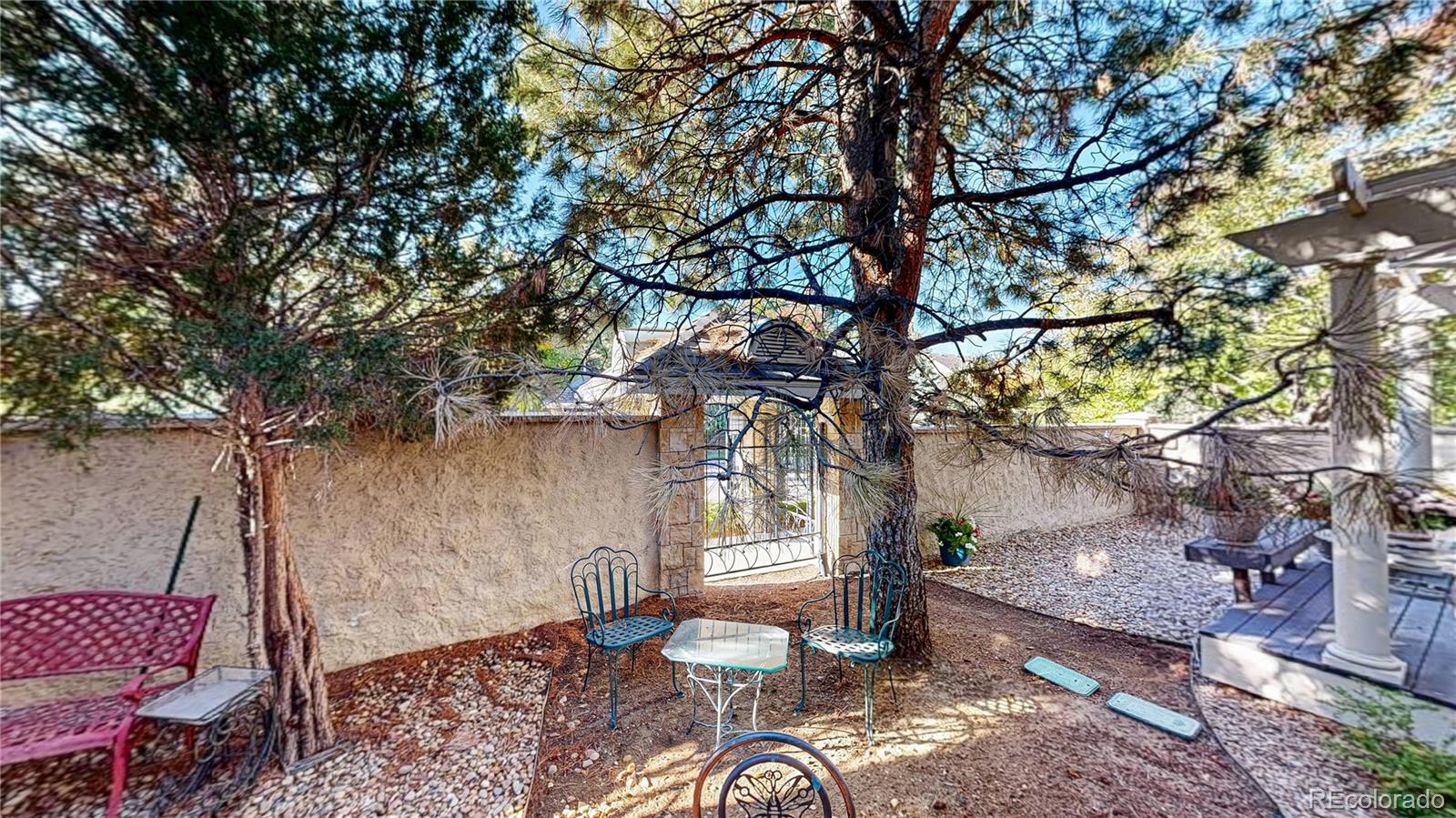 4545 South Monaco Street, Unit 138 Denver, CO 80237 - Photo 29 of 34 a backyard of a house with table and chairs