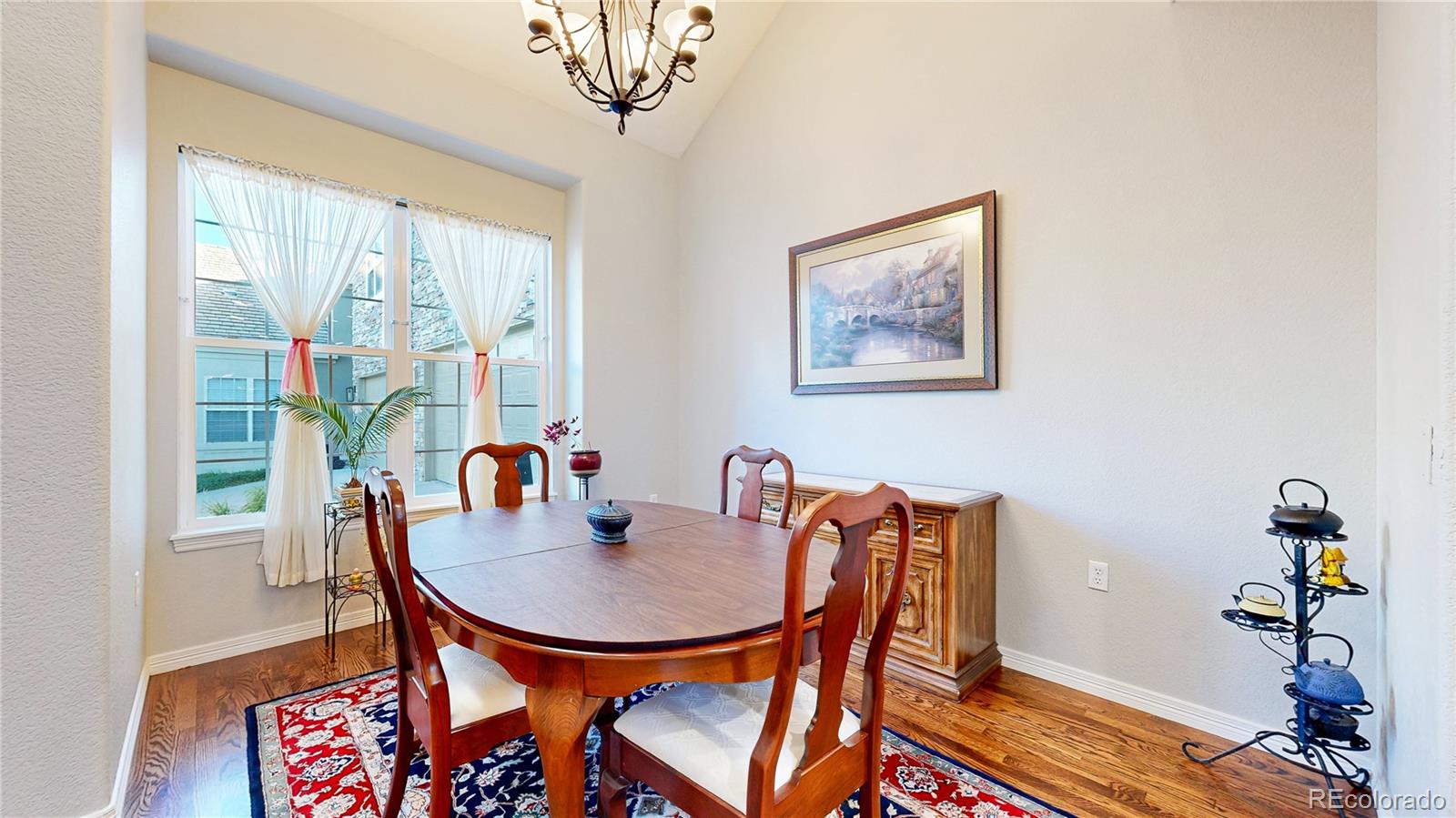 4545 South Monaco Street, Unit 138 Denver, CO 80237 - Photo 5 of 34 a dining room with furniture and wooden floor