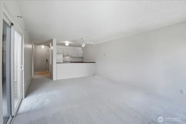 a utility room with granite countertop cabinets washer and dryer