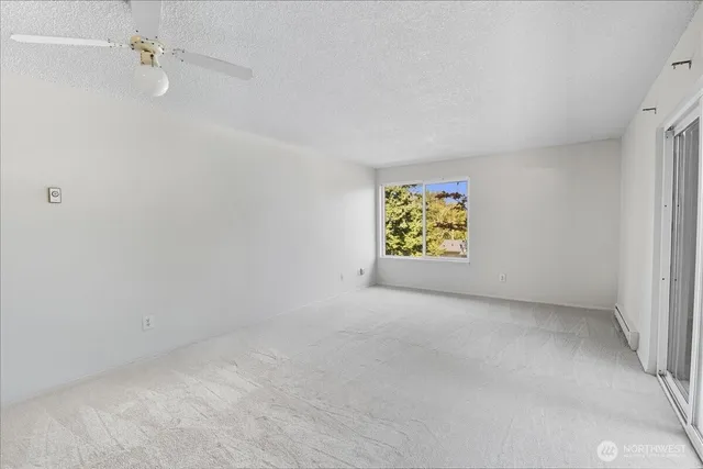 an empty room with closet and windows