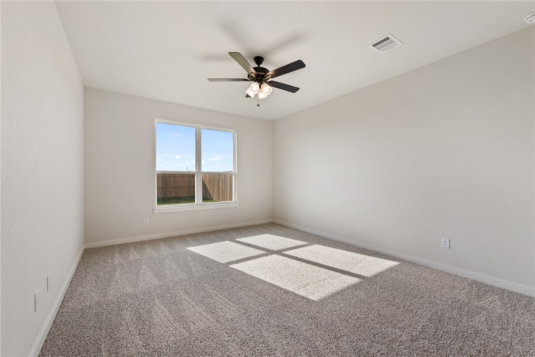 2415 Rooke Road Bryan, TX 77807 - Photo 24 of 36 an empty room with windows and fan