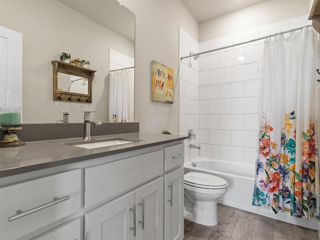 270 Lunayena Road Rhome, TX 76078 - Photo 8 of 37 The guest bathroom features a functional layout with vanity space, a shower/tub combination, and convenient access for guests and secondary bedrooms, designed for everyday use and comfort.