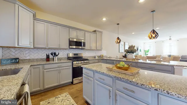 a kitchen with a sink a stove and cabinets