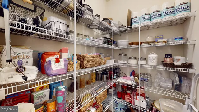 a kitchen with granite countertop stainless steel appliances white cabinets and a window