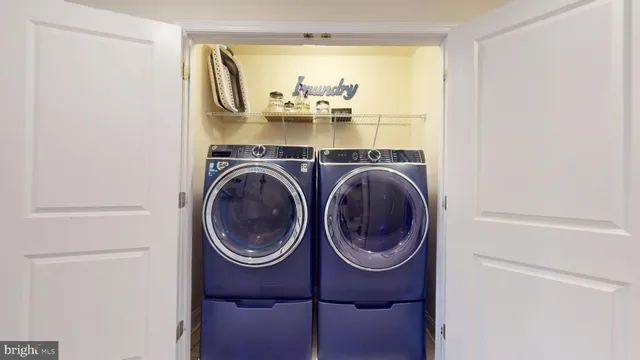 a bedroom with a bed and a chandelier fan