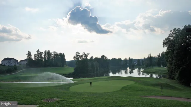 a front view of a house with a garden and parking