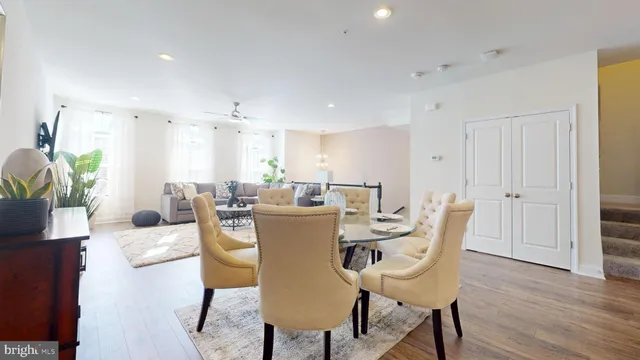 a kitchen with stainless steel appliances granite countertop a sink a stove and a wooden floors