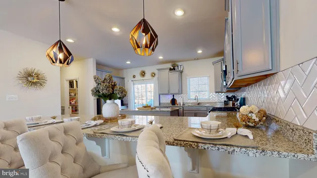 a living room with furniture kitchen and a window