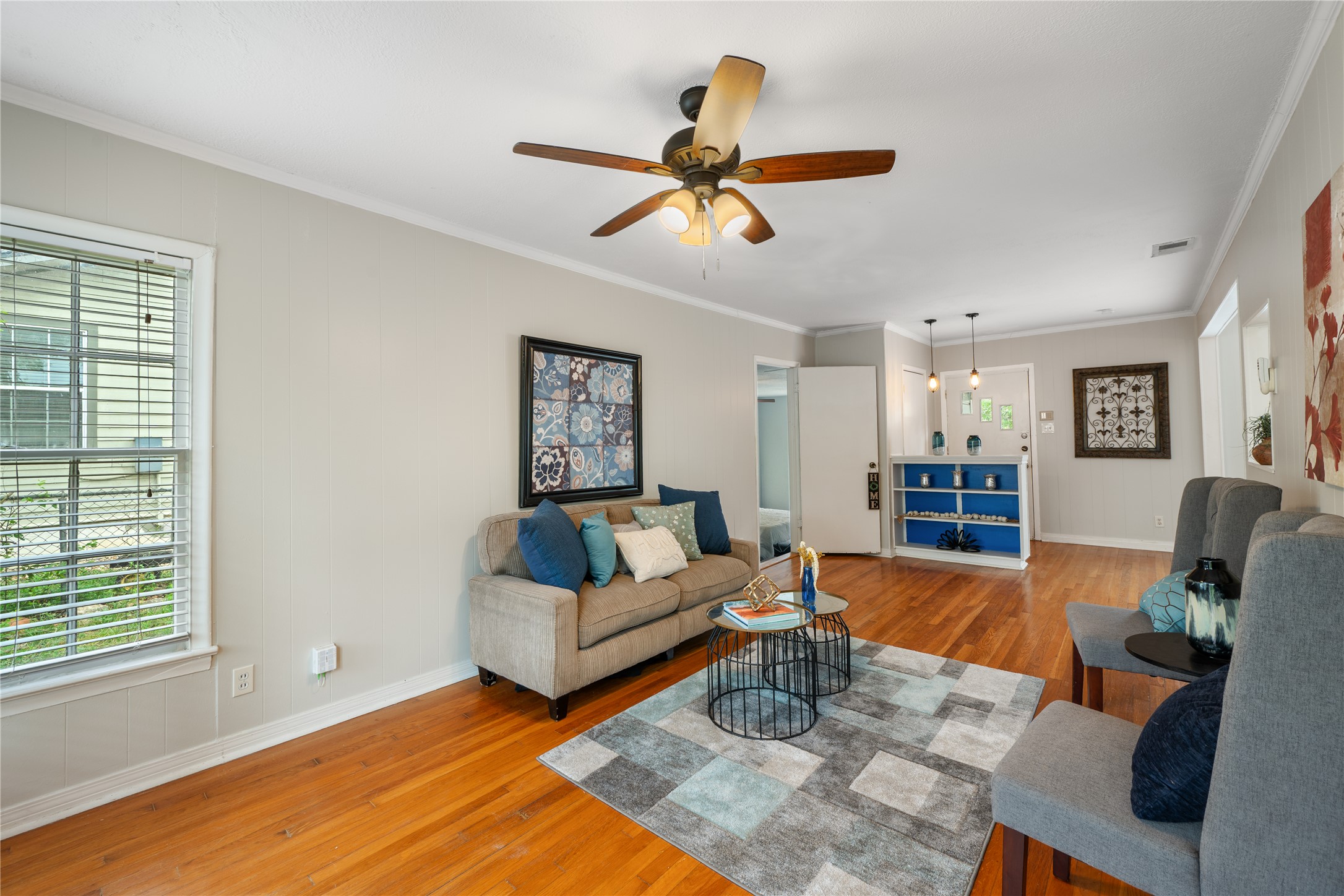 2639 West 45th Street Austin, TX 78731 - Photo 12 of 29 Living room featuring crown molding, light wood finished floors, and ceiling fan