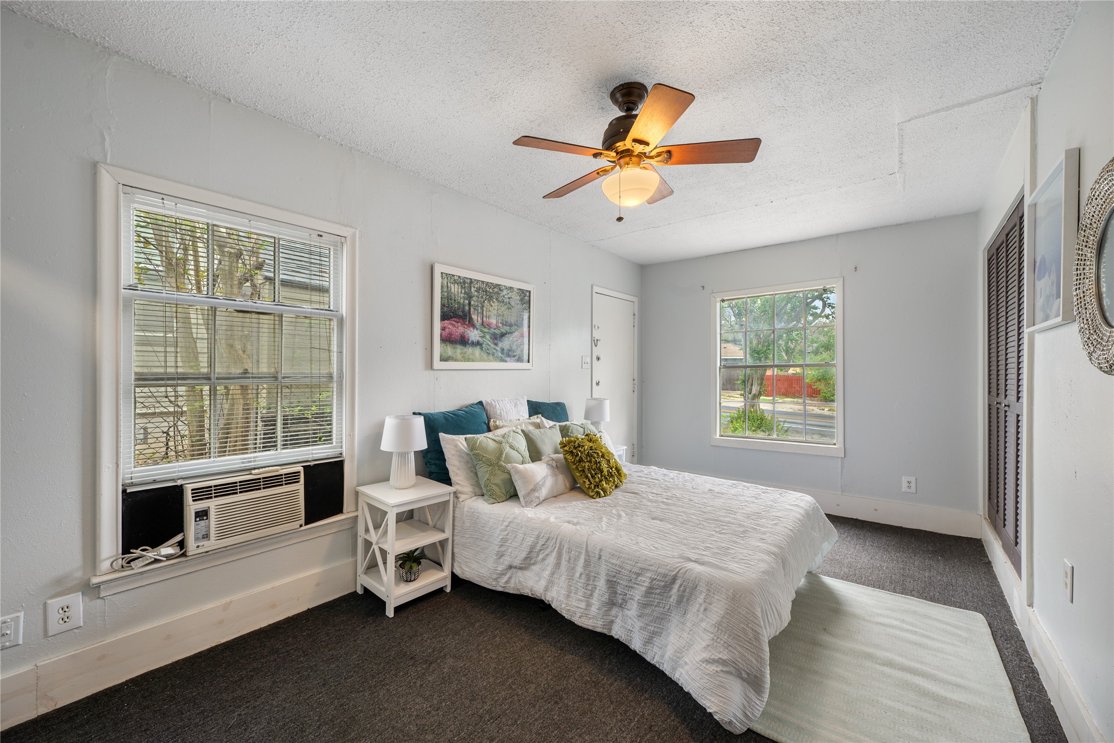 2639 West 45th Street Austin, TX 78731 - Photo 19 of 29 Bedroom featuring a textured ceiling, carpet, ceiling fan, and cooling unit