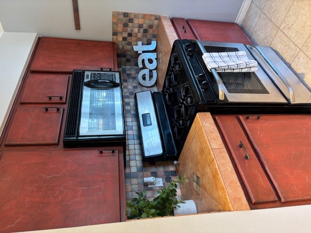 2639 West 45th Street Austin, TX 78731 - Photo 22 of 29 Kitchen featuring stainless steel gas stove, black microwave, decorative backsplash, and light tile patterned floors