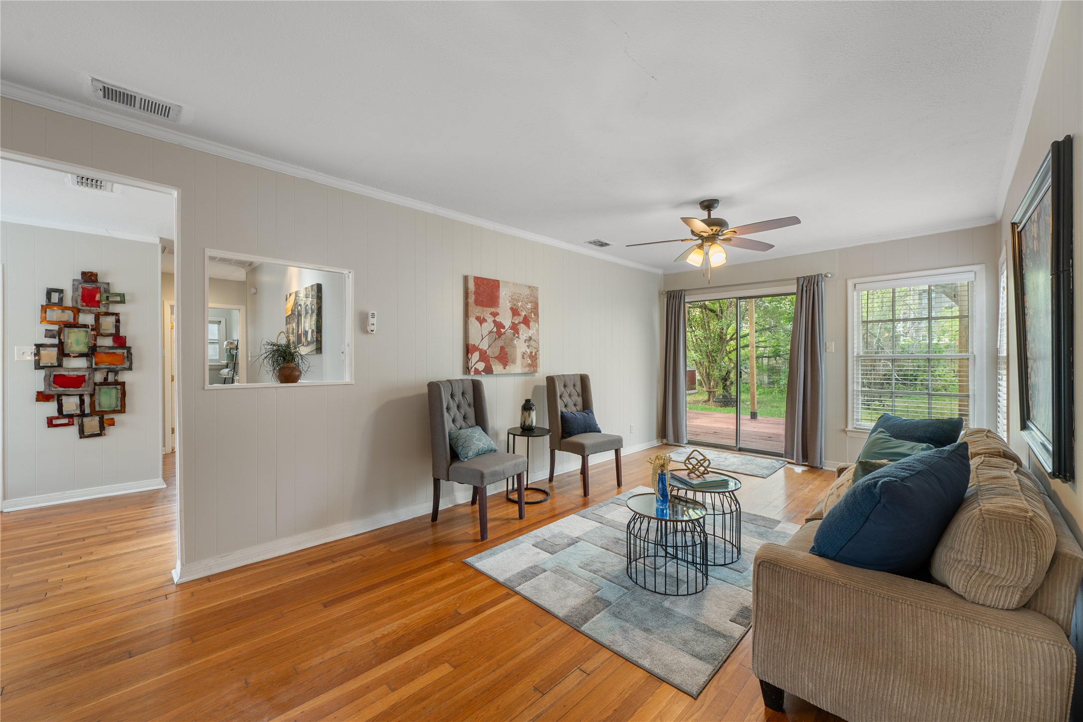 2639 West 45th Street Austin, TX 78731 - Photo 3 of 29 Living area featuring light wood finished floors, ornamental molding, and ceiling fan