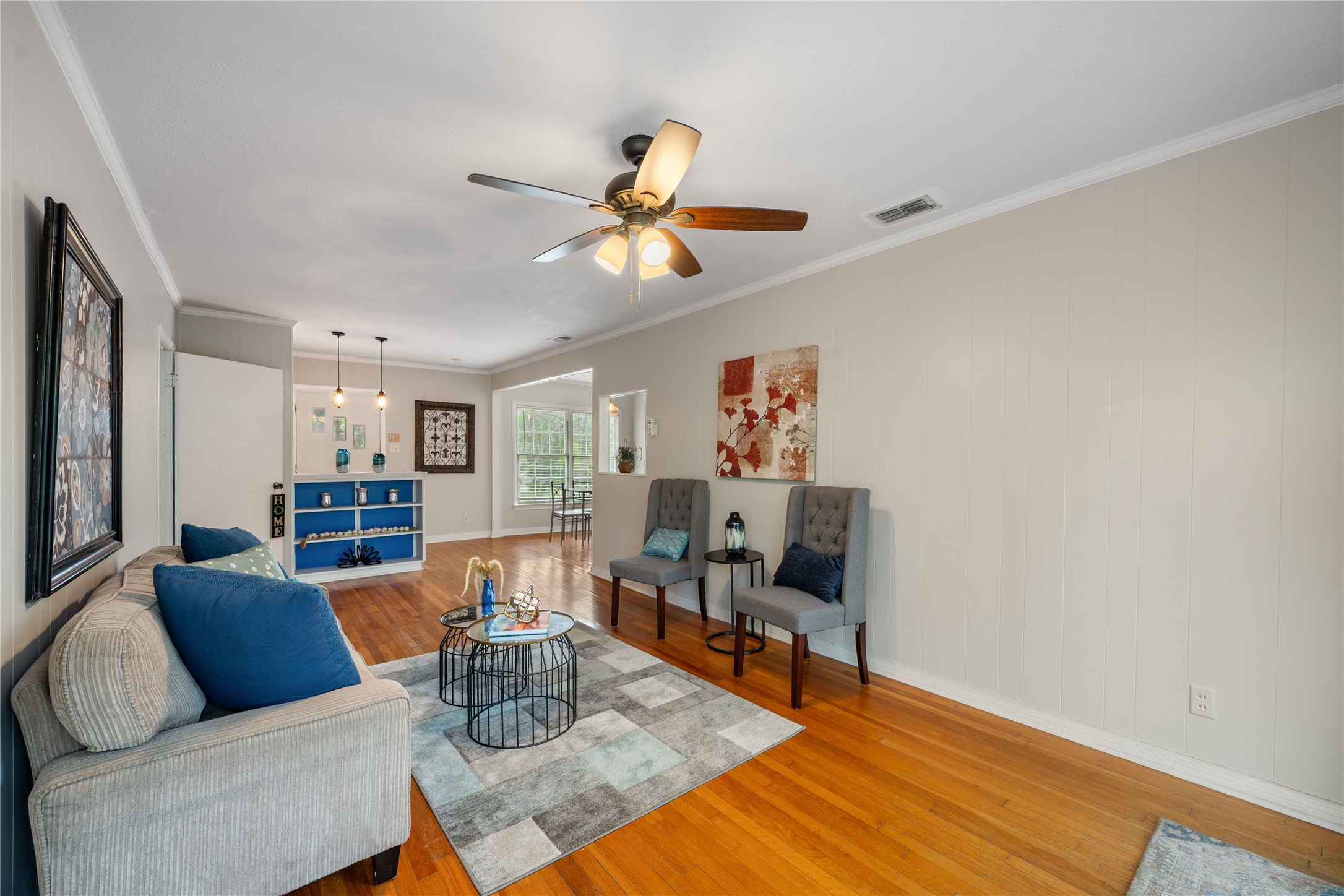2639 West 45th Street Austin, TX 78731 - Photo 4 of 29 Living room featuring ornamental molding, light wood-style floors, and a ceiling fan