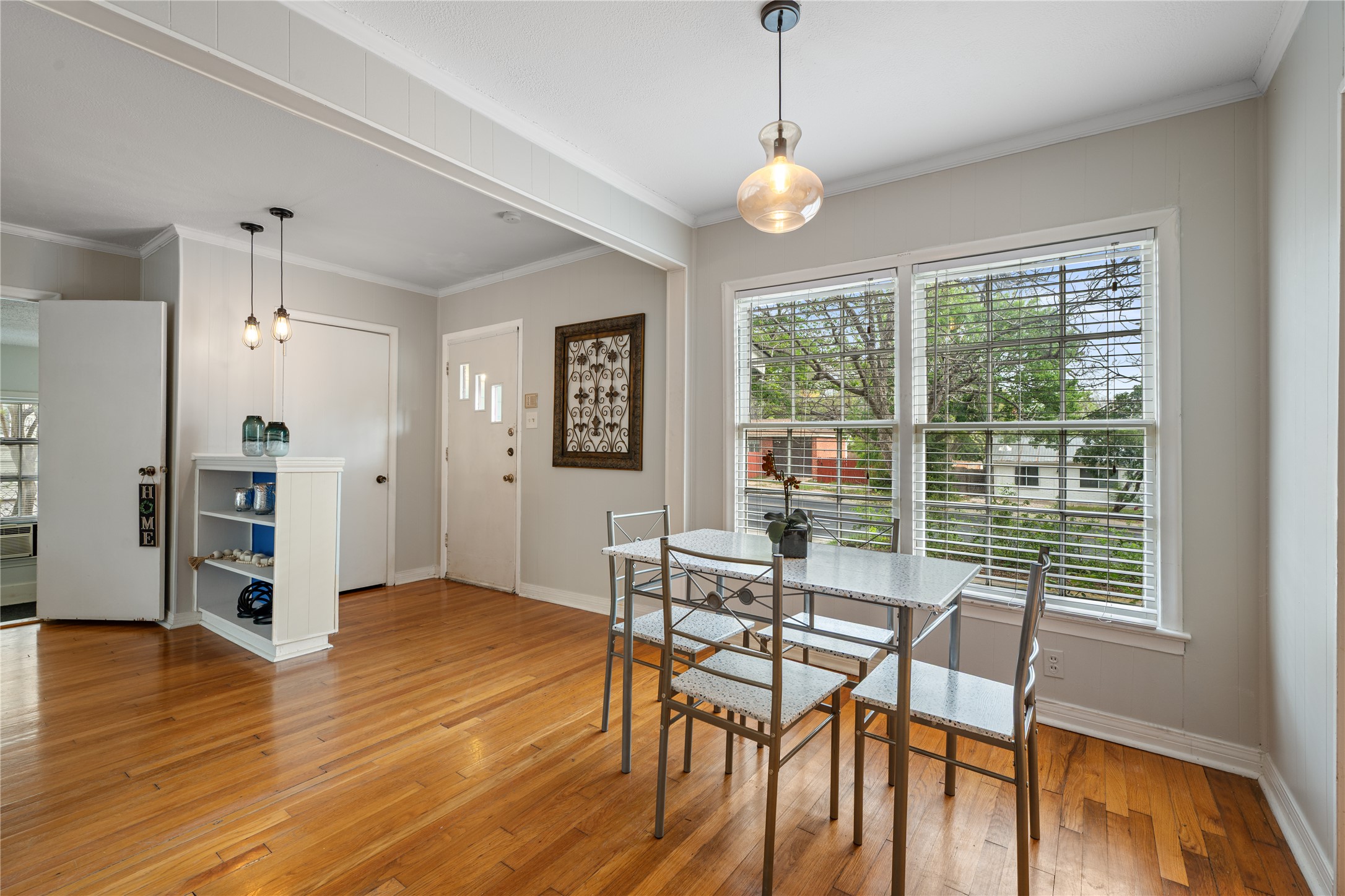 2639 West 45th Street Austin, TX 78731 - Photo 6 of 29 Dining area featuring ornamental molding and light wood finished floors