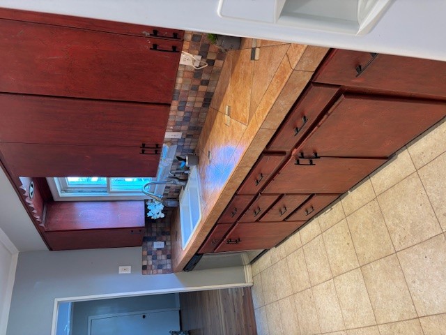 2639 West 45th Street Austin, TX 78731 - Photo 7 of 29 Kitchen with tile counters, backsplash, dishwasher, white refrigerator with ice dispenser, and ornamental molding