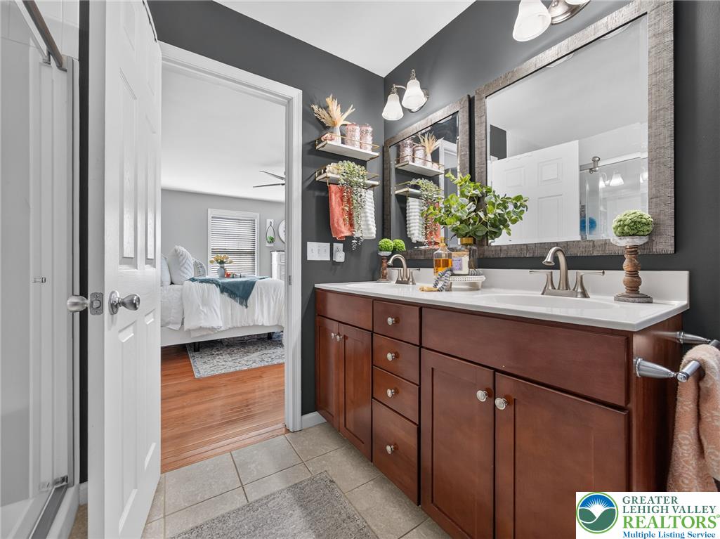 4148 Ross Road Bethlehem, PA 18020 - Photo 56 of 67 Double vanities and contemporary fixtures enhance this functional bathroom, offering direct access to the primary bedroom.