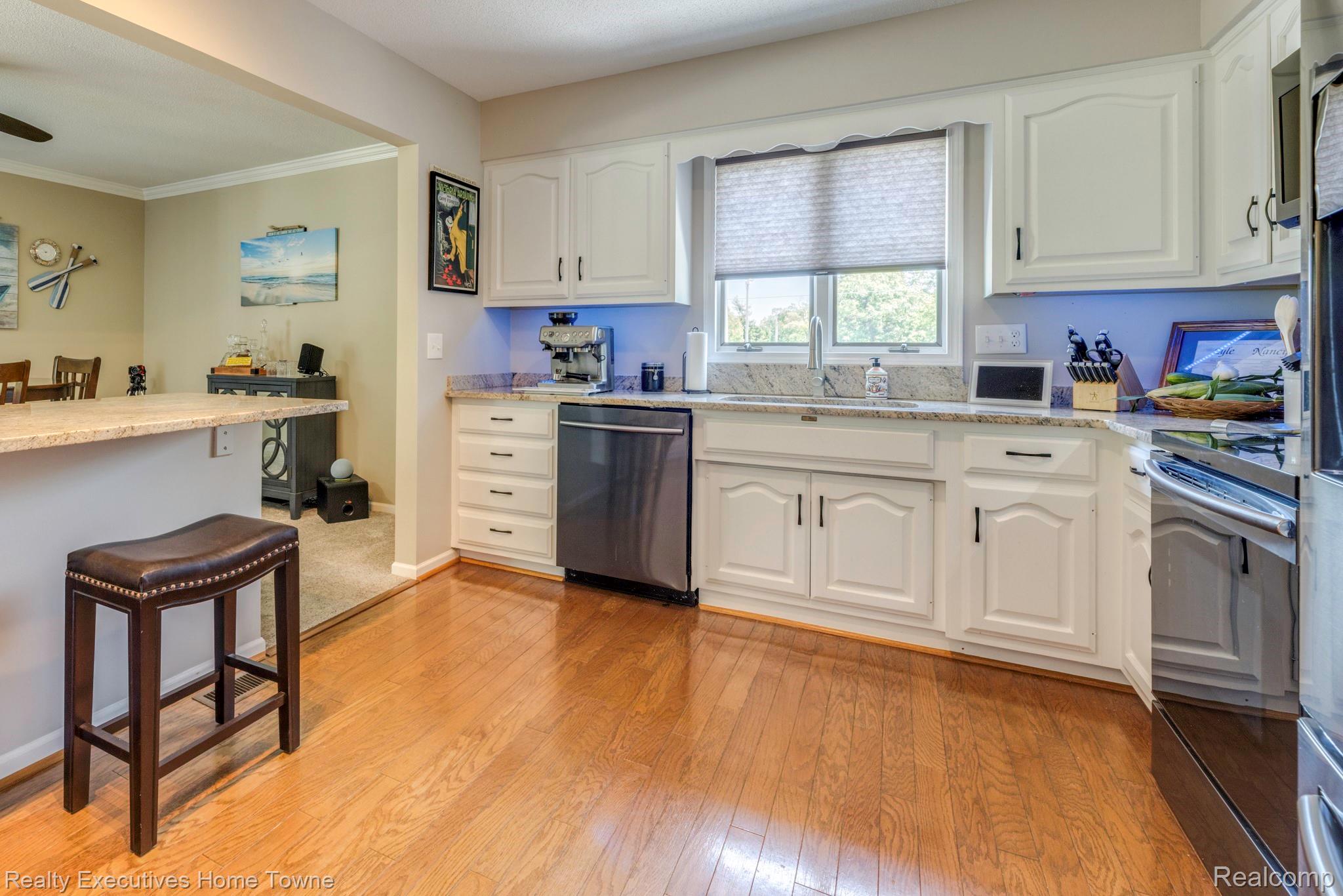 1467 Krafft Road, Unit 8 Port Huron, MI 48060 - Photo 13 of 30 Kitchen featuring white cabinetry with dark hardware, a stainless steel dishwasher, and a built-in oven