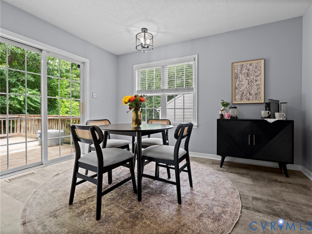 6712 Hedges Road Richmond, VA 23224 - Photo 10 of 34 Dining area featuring light gray walls and wood-fi