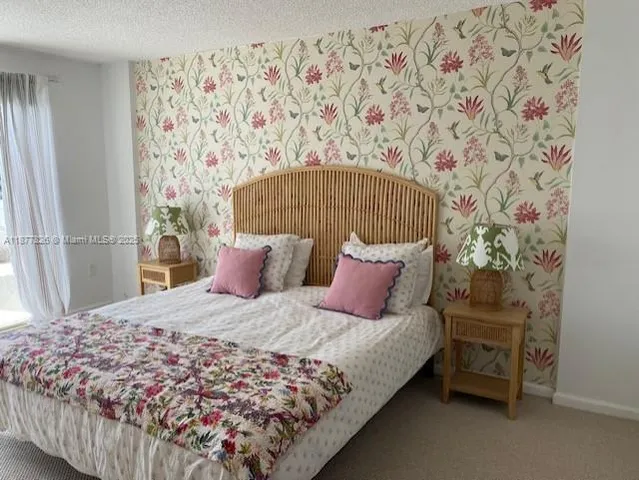 a bedroom with two beds and a window