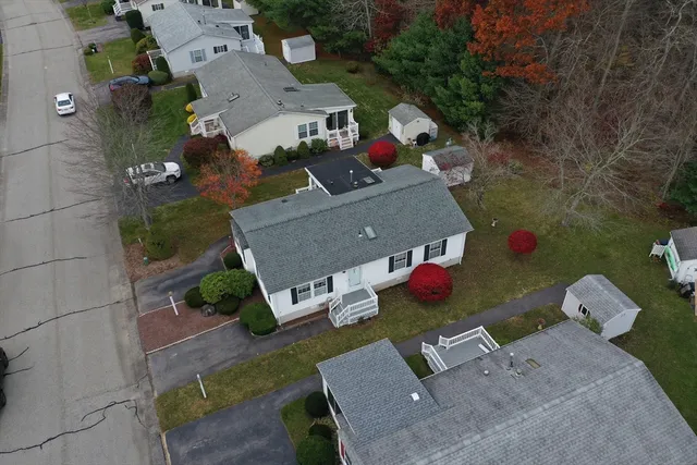 a aerial view of a house with yard and outdoor seating