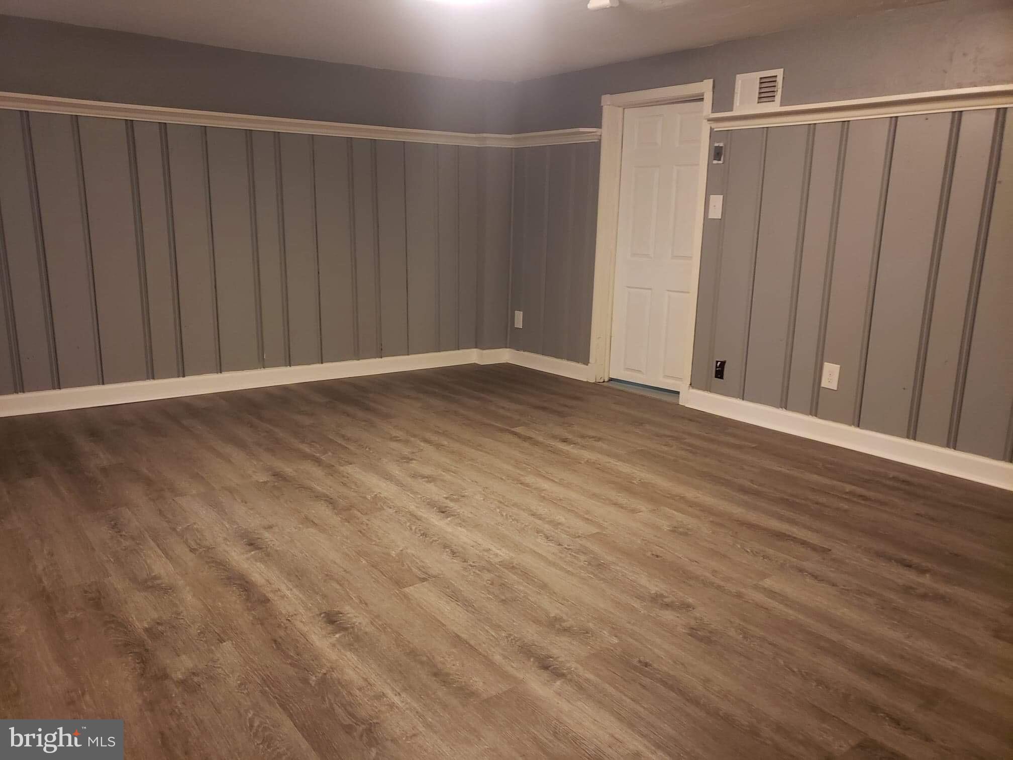 213 Westowne Road Baltimore, MD 21229 - Photo 13 of 20 a view of an empty room with wooden floor