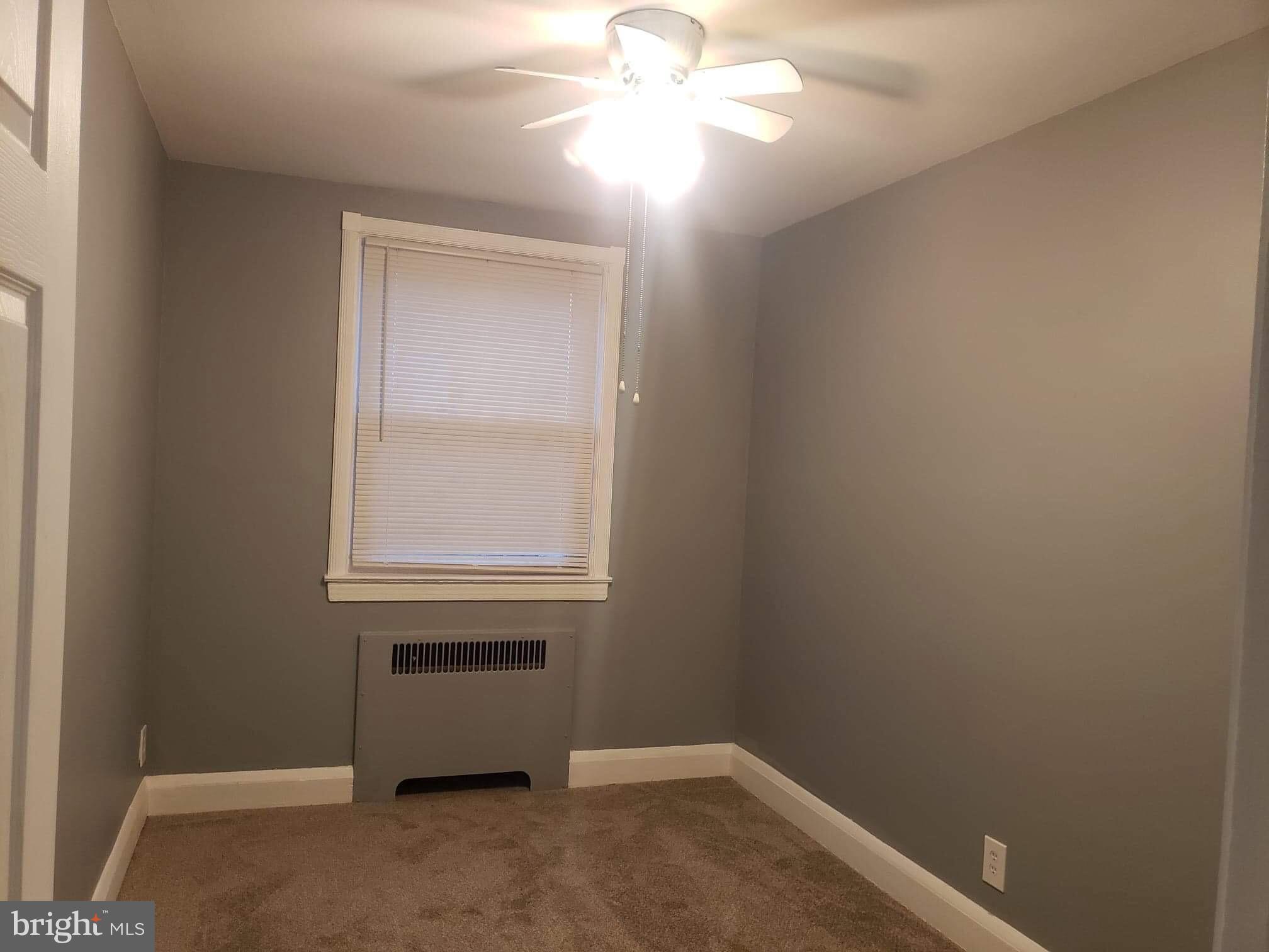 213 Westowne Road Baltimore, MD 21229 - Photo 14 of 20 an empty room with a window and a fan